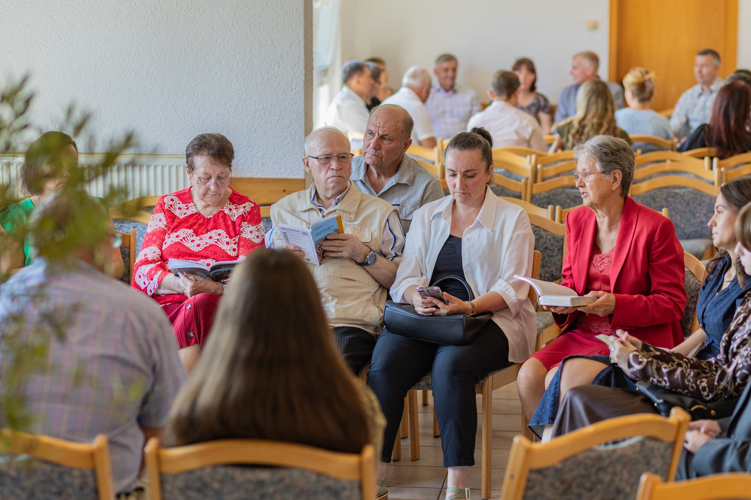 Ältere und jüngere Gemeindeglieder sitzen zusammen im Gesprächskreis