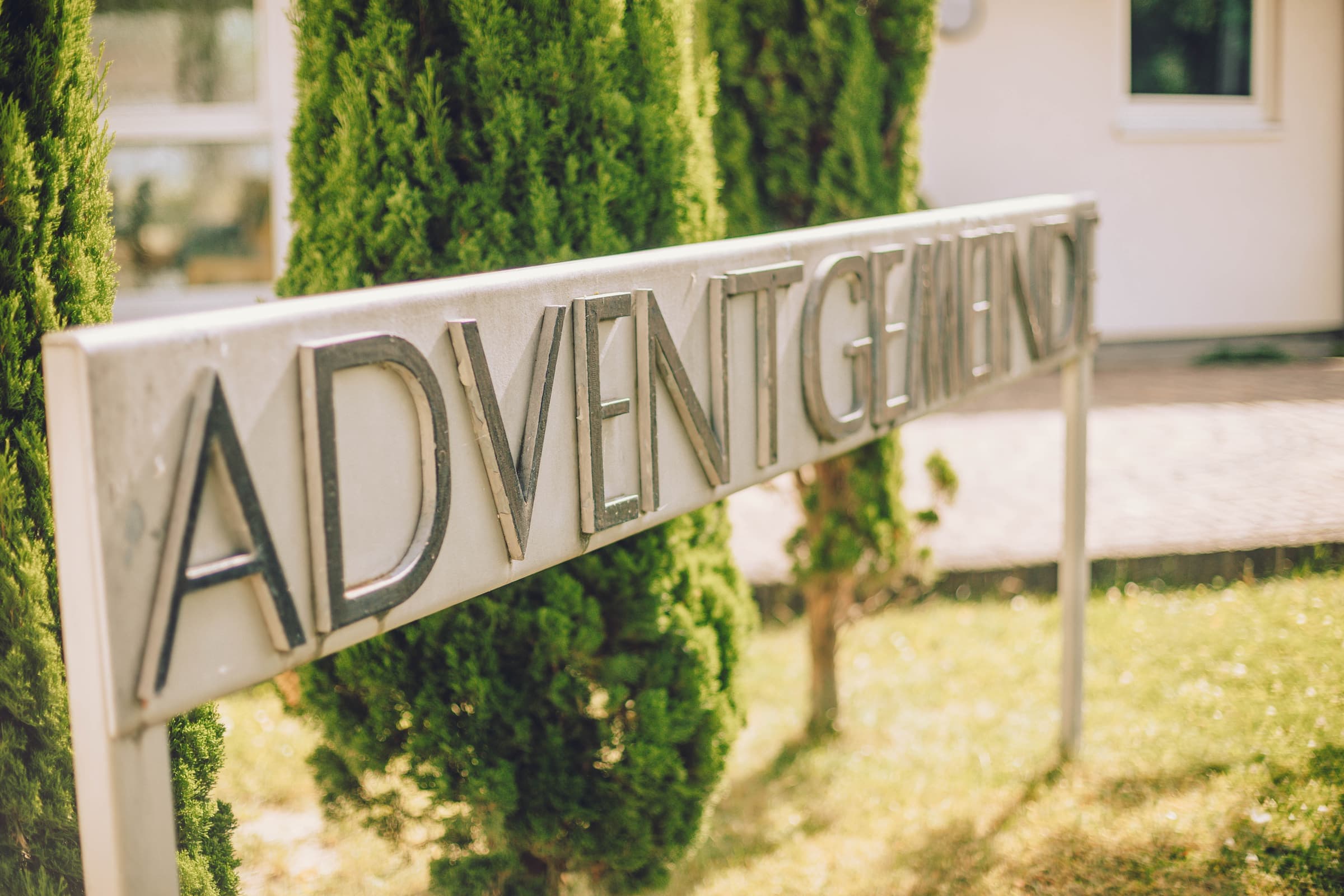 Schild mit der Aufschrift Adventgemeinde vor dem Gemeindehaus